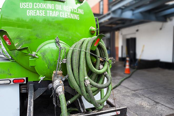 a service truck pumping grease from a restaurant's grease trap in Hanford