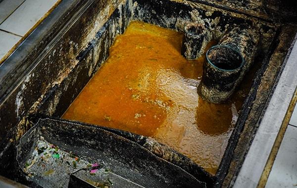 foul odors, slow drainage, and grease build-up in drains are signs that a grease trap requires cleaning